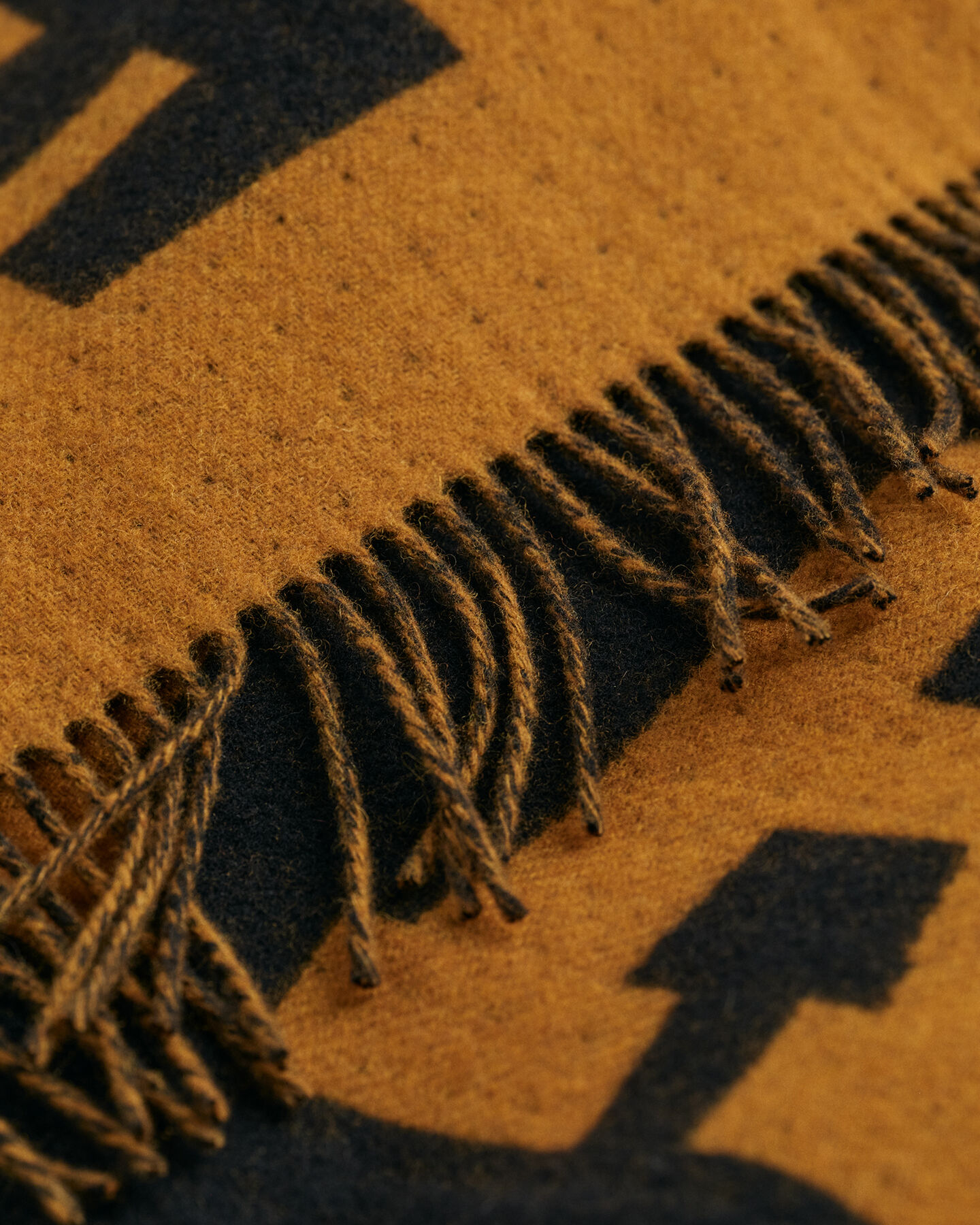 Poncho en laine Logo